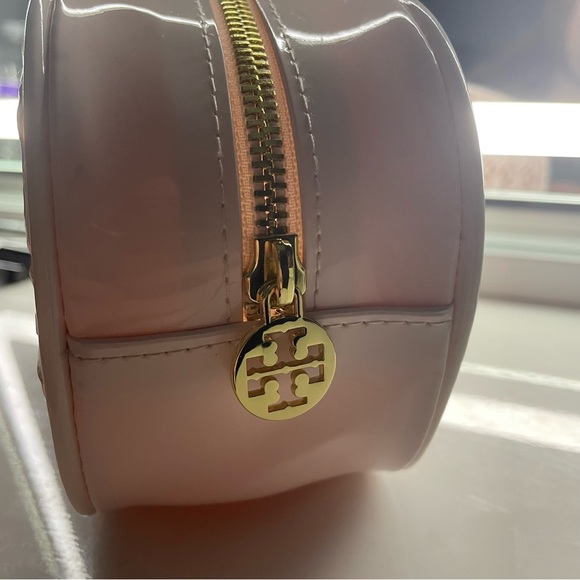 Tory Burch Handbags - Tory Burch cosmetic bag in a patent pink with gold zipper.